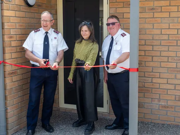 Salvos officer cutting a ribbon